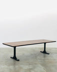 The SOBU Mars Live Edge Dining Table features an American walnut top with a smooth surface and two black T-shaped metal legs, shown on a concrete floor against a plain white background.