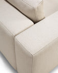 Close-up of the Mellow Modular Sofa by Ethnicraft in Off White, highlighting its textured, stain-resistant Italian fabric and the clean, modern lines of its cushions and armrest.