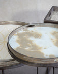 The Ethnicraft Mist Gold Organic Glass Tray (Round/Small) features a hand-painted, marbled gold pattern on glass, adding artistic elegance atop its neutral background.