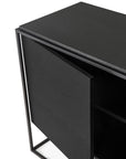 Close-up of the Ethnicraft Monolit Sideboard - 2 door in black, showcasing its matte finish, sleek black metal frame, and visible interior shelves through a partially open door.