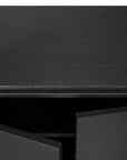 Close-up of the Ethnicraft Monolit Sideboard - 2 door in black, featuring partially opened doors that reveal a dark interior. The wood grain texture on its solid European oak surface highlights quality craftsmanship.