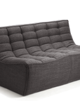 The Ethnicraft N701 Sectional Sofa in dark grey features a modern armless design with tufted quilting and a low backrest, highlighting sleek European style against a white background.