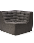 The Ethnicraft N701 Sectional Sofa - Dark Grey features modern, tufted grid-pattern cushions and a low, boxy European design, shown here as an upholstered corner chair set against a plain white background.