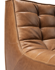 Close-up of the N701 Modular Sofa - Old Saddle by Ethnicraft, featuring tufted cushioning, full aniline leather, and visible stitching for a refined texture and craftsmanship.