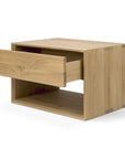 The Ethnicraft Nordic II Bedside Table is crafted from solid European oak and features a modern design with one partially open drawer above an open storage space.