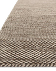 Close-up of the Oakwood Rug - Stone by Loloi, showing its beige and brown textured looped pattern and finished edge.