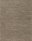 A close-up of the Oakwood Rug - Stone by Loloi shows its textured brown woven fabric, crafted from natural wool with a subtle small-scale pattern and narrow, darker borders along the top and bottom edges.