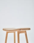 The Odd Counter Stool | Leather by Wooden Stories features a minimalist oak design with leather seating and four legs, shown against a plain white background—ideal for stylish, modern kitchen island seating.