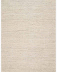 The Omen Rug - Mist by Loloi is a rectangular, hand-woven beige area rug with subtle chevron waves, textured horizontal lines, and fringed edges, shown on a white background.