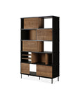 The Oscar Rack - Teak by Ethnicraft features a black frame, natural solid teak shelves and drawers, asymmetrical open and closed storage, and slim black legs, shown here against a white background.