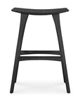 The Ethnicraft Osso Barstool - Black is crafted from black stained solid oak, featuring a curved seat and four angled legs joined by two horizontal support bars.