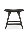 The Osso Dining Stool - Black with leather seat by Ethnicraft features a curved seat and angled legs, merging classic European refinement with modern design—shown from the front on a white background.