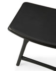 Close-up of the Ethnicraft Osso Dining Stool in black, highlighting its smooth rectangular leather seat and black-stained oak legs for a touch of classic European refinement.