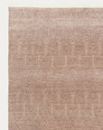 The Armadillo&Co Paragon Rug - Primrose is a handmade rectangular wool rug in soft pink and beige gradient tones, featuring subtle textured details and a slight fringe on the top edge.