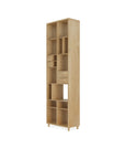 The Pirouette Rack - Oak by Ethnicraft features multiple open cubby shelves and three small drawers, standing on short legs, set against a white background.