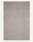 The Pompeii Rug - Rye by Armadillo&Co is a rectangular, flat-woven rug in neutral beige and gray with a subtle herringbone pattern. Made from New Zealand felted wool, its off-white background emphasizes the simple texture.