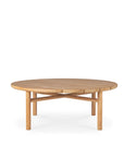 The Quatro Outdoor Coffee Table by Ethnicraft features a round, light teak top and four straight legs with crossbars, making it an ideal choice for both modern indoor or outdoor spaces.