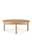 The Ethnicraft Quatro Outdoor Coffee Table is crafted from teak, featuring a round, smooth surface and four cylindrical legs, showcased against a white background.