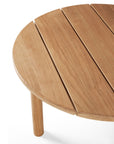 Close-up of the Ethnicraft Quatro Outdoor Coffee Table - Teak, featuring a round top with three visible slats and one leg, crafted from light-colored teak and set against a white background.