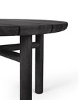 Close-up of the Ethnicraft Quatro Outdoor Side Table 23.5 in black teak, featuring a round Grade A teak tabletop and three sturdy cylindrical legs against a white background.