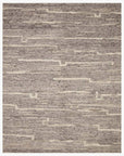 The Loloi Rayan Rug - Charcoal/Ivory is hand-woven with a textured pattern of uneven beige and gray lines on a neutral base, giving it a modern, abstract look in soothing tones.