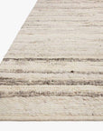 A close-up of the Loloi Rayan Rug - Natural/Grey shows cream and light grey horizontal stripes on white, with a soft, thick texture that highlights its quality wool craftsmanship.