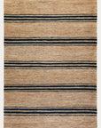 The River Rug - Natural & Indigo by Armadillo&Co features a rectangular shape with a natural tan base and evenly spaced indigo stripes. This hand-woven rug boasts a simple, minimalist design for a timeless look.