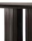 Close-up of the Ethnicraft Roller Max Round Dining Table in dark mahogany, featuring two pedestal legs with vertical slats and a smooth, rounded tabletop.