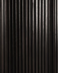 Close-up of a dark mahogany wooden surface with vertical grooves and a ribbed texture, reflecting light, inspired by Ethnicrafts Roller Max Round Dining Table - Dark Mahogany.
