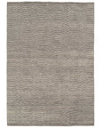 The Savannah Rug - Dust by Armadillo&Co is a rectangular grey rug featuring subtle chevron and zigzag patterns with textured, raised lines evenly spaced across the surface.