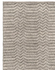 The Savannah Rug - Dust by Armadillo&Co features a textured, three-dimensional zigzag pattern in light gray and beige, blending natural elegance with layered design.