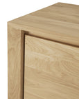 Close-up of the top corner of Ethnicraft’s Shadow Sideboard - 2 door, crafted from European oak and showcasing its smooth grain, minimalist modern design, clean lines, and handle-free aesthetic.