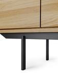 Close-up of the Ethnicraft Shadow Sideboard with Legs - 88, showcasing a minimalist design with clean lines, black metal legs, and a light European oak finish.