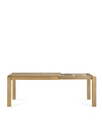 The Ethnicraft Slice Extendable Dining Table - Oak is a rectangular wooden table made from European oak, shown partially extended to display its extendable mechanism. It features a natural wood finish and a minimalist design.