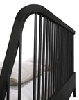 Close-up angled view of Ethnicraft’s Spindle Bed in Black Oak, featuring vertical slats and crafted from solid European oak, shown with a mattress and light-colored bedding.