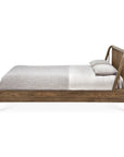 The Spindle Bed - Teak by Ethnicraft features a minimalist reclaimed FSC-certified teak frame and a slightly angled slatted headboard, styled with white and light gray bedding plus two matching pillows against a white background.