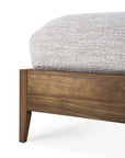 Close-up of the Ethnicraft Spindle Bed - Teak, crafted from reclaimed FSC-certified wood, with a light gray textured comforter folded over the corner, set against a white background.