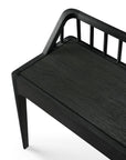 The Ethnicraft Spindle Bench - Black Oak features minimalist design with a flat seat, angled backrest, and slim vertical slats, all crafted from European oak in a dark finish for a modern look.