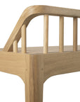 Close-up of the Ethnicraft Spindle Bench - Oak, featuring smooth, rounded edges and vertical backrest slats crafted in solid European oak with a natural grain finish.