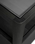 Close-up, angled view of the Ethnicraft Spindle Nightstand in Black Oak, highlighting its smooth, rounded edges and matte finish that showcase the craftsmanship and rich texture of solid European oak.
