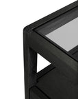 Close-up of the Spindle Nightstand in Black Oak by Ethnicraft, featuring minimalist design, a glass top, and clean lines, set against a white background.