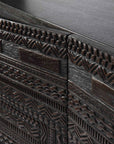 Close-up of the Ethnicraft Tabwa Sideboard - 3 door, showcasing detailed hand-carved geometric patterns on its dark wood front panels, inspired by Tabwa culture and emphasizing expert craftsmanship.