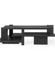 The Teak Abstract Coffee Table by Ethnicraft is a modern black wooden piece inspired by the de Stijl movement, featuring a geometric, layered design with multiple rectangular shelves at varying heights and angles.