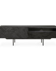 The Ethnicraft Graphic TV Cupboard - 63 is a black wooden media console with geometric textured front panels, four slim legs, one open compartment, and two compartment doors—one shown open.