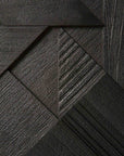 Close-up of a geometric pattern crafted from dark wood, echoing the Ethnicraft Graphic TV Cupboard - 63 with overlapping triangles and rectangles that highlight the rich grain and textured surfaces.