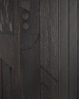 Close-up of a dark wood panel from the Ethnicraft Mosaic Sideboard - 4 door, showing geometric carved patterns—vertical lines, circles, curves, and textured details—that highlight rich wood grain and expert craftsmanship.