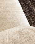 Close-up of SOBUs Woody Sofa SAMPLE_(DZ) in beige textured fabric with high-density foam cushions, shown in the foreground with a dark woven rug in the background.