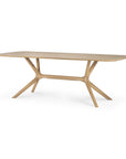 Ethnicrafts X Dining Table - Oak features a rectangular shape with rounded edges, a light European oak finish, and angled legs joined by a central support beam, reflecting the brand’s renowned craftsmanship.
