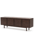 The Yorke Sideboard by Wooden Stories features a modern Danish design with dark wood, four cabinet doors, minimalist Scandinavian style, and slender rectangular legs, showcased against a white background.