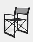 The Harbour Pacific Folding Chair - Black Teak is a modern, black, foldable director’s chair with a straight frame, mesh back and seat, and X-shaped support—ideal for stylish outdoor furniture settings.